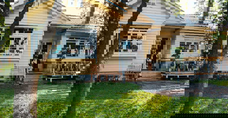 Charming Yellow House With Wooden Windows Green Grassy Garden (1) (1)